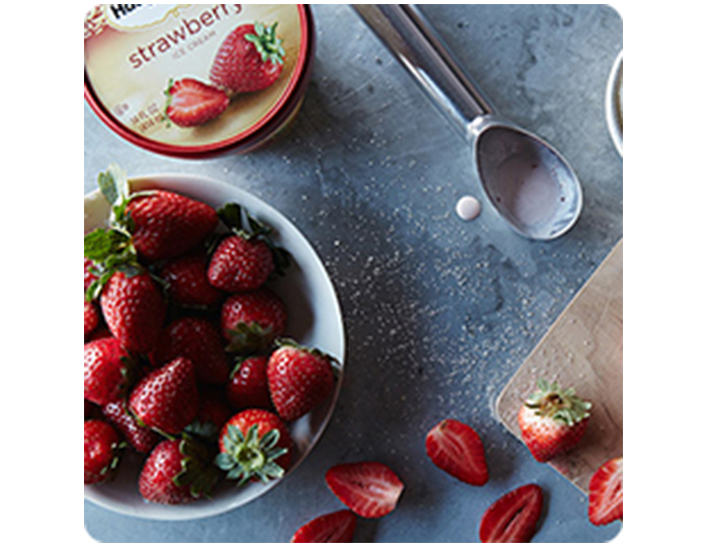 Fresh strawberries in a bowl and Haagen-Dazs strawberry ice cream