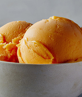 Scoops of Haagen-Dazs mango sorbet in a bowl