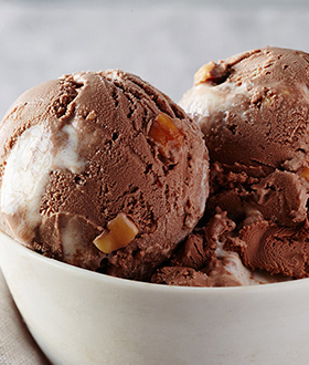 Scoops of Haagen-Dazs rocky road ice cream in a bowl