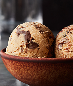 Scoops of Haagen-Dazs spirits whiskey hazelnut ice cream in a bowl