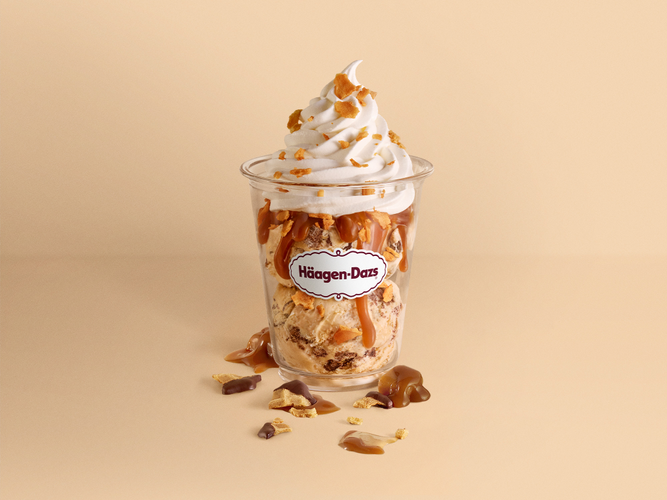 Caramel Cone Sundae Caramel Cone Ice Cream with chocolate-covered cone pieces and caramel swirls, laced with waffle cone pieces, drizzled with warm caramel, and topped with whipped cream.