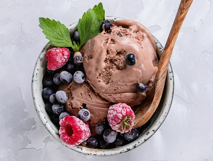 bowl of chocolate ice cream, fresh berries and mint