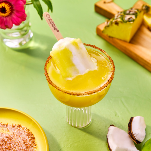 Put the Pineapple in the Coconut This bold tropical refresher combines sweet pineapple, fizzy coconut water, and a kick of cayenne for a sweet-heat sensation. Finished with a Outshine Pina Colada Fruit Blends bar, it’s a vibrant sip with a fiery twist.