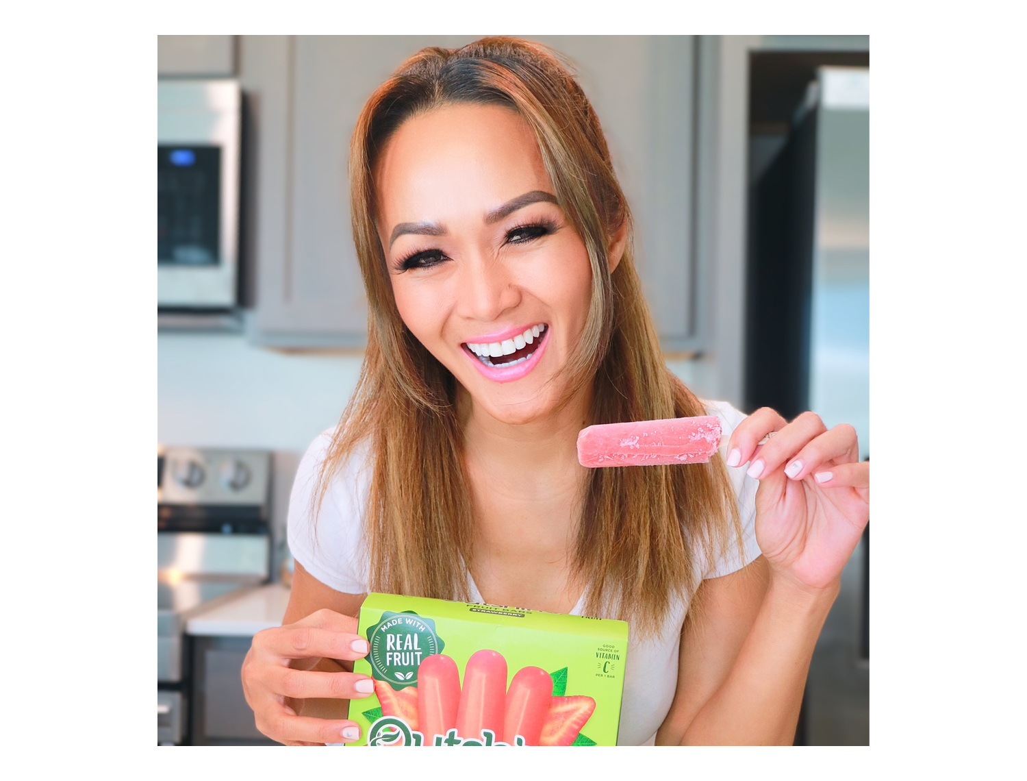 Laughing girl holding Outshine fruit bar